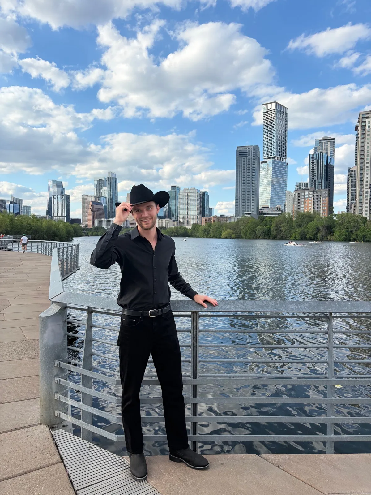 Gary Davisson tipping his cowboy hat by Lady Bird Lake, Austin